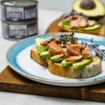 featured image of canned smoked wild coho salmon with avocado on toast with more cans in the background